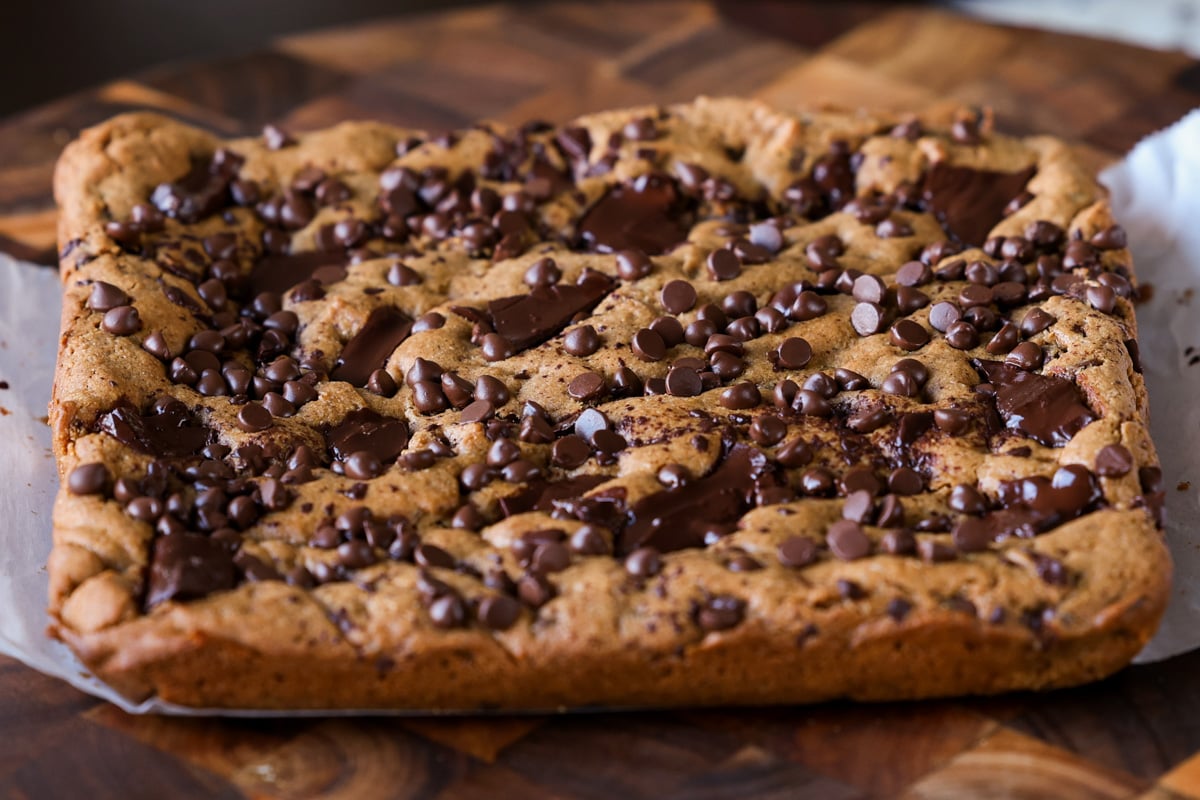 almond butter blondies on a cutting board after baking and cooling