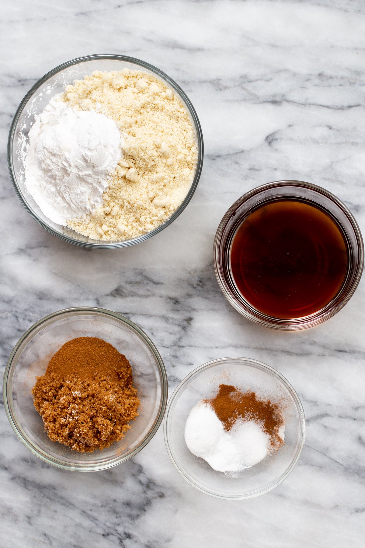 ingredients for making vegan snickerdoodle cookies on a marble countertop