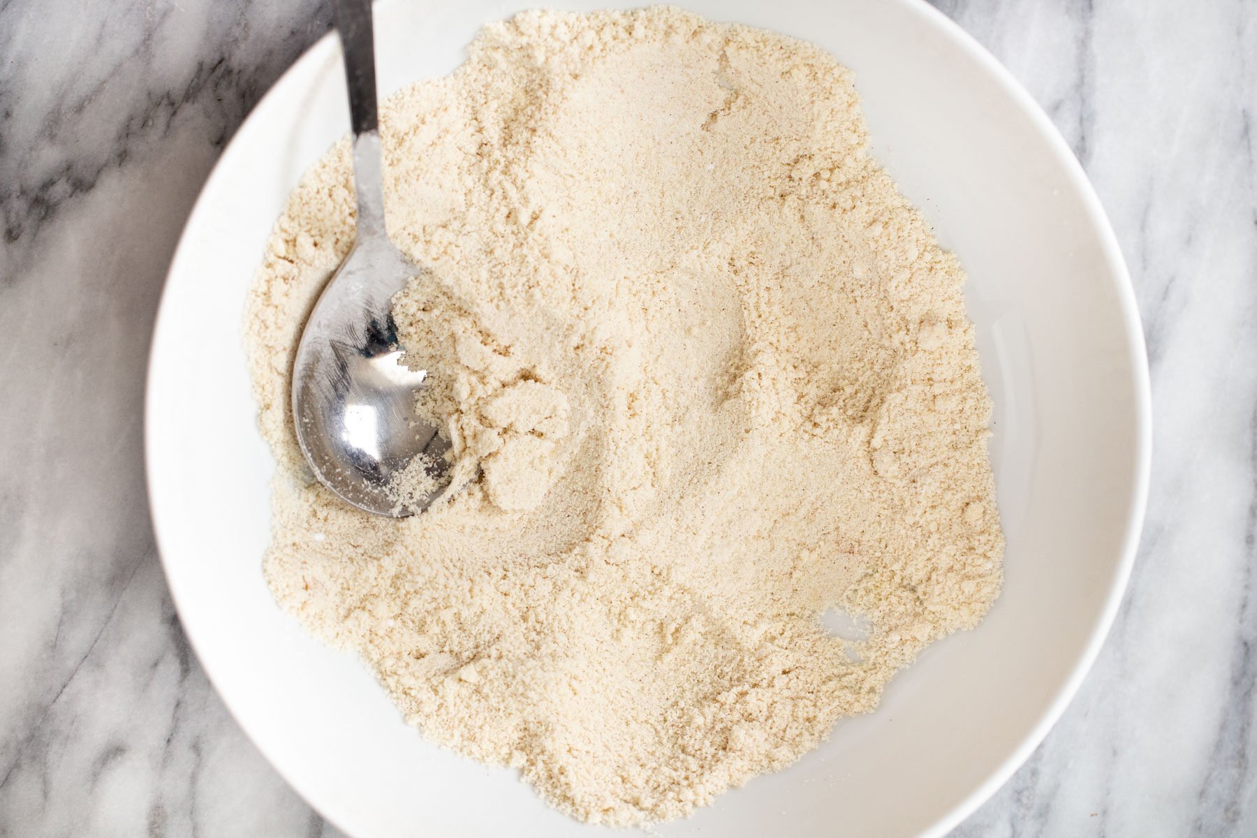 dry ingredients for vegan snickerdoodle cookie batter in a bowl 