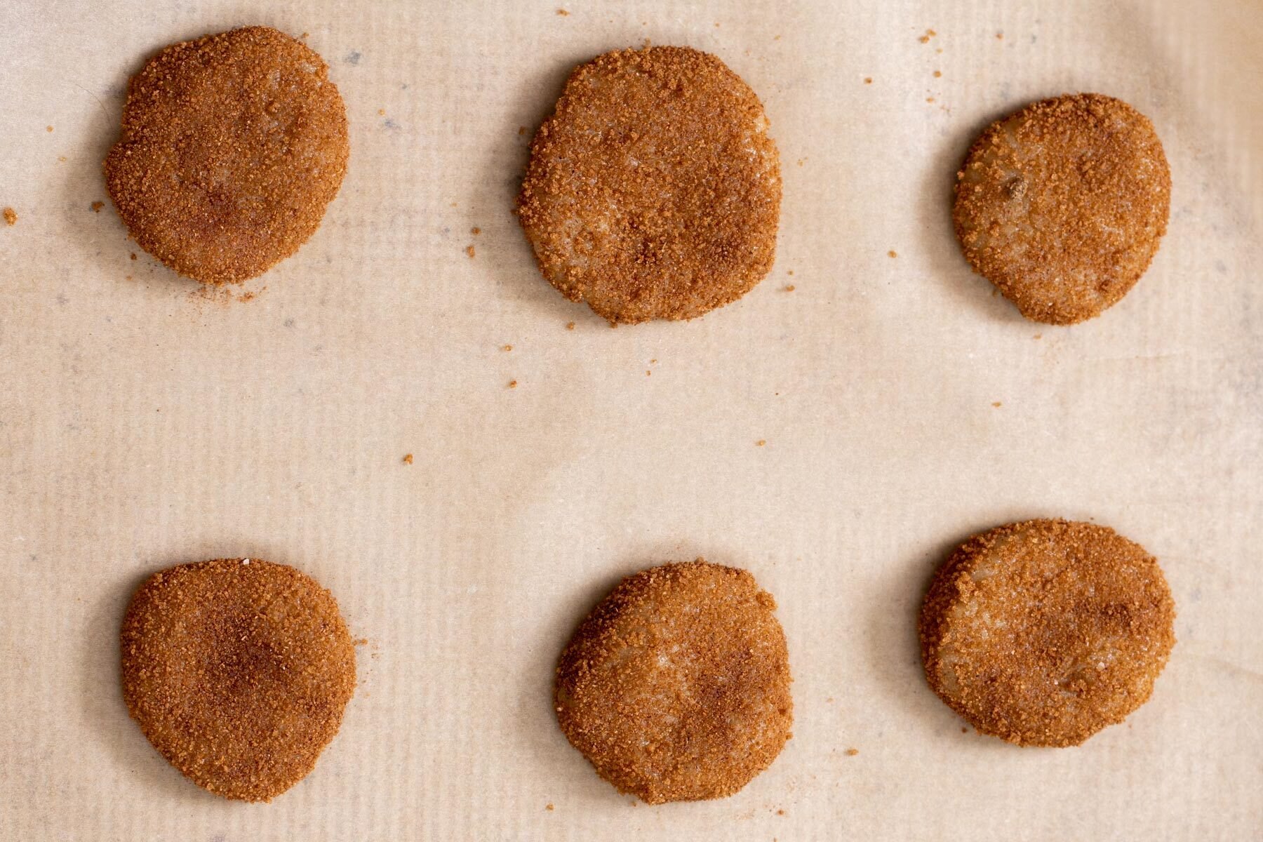 snickerdoodles cookie batter on a lined sheetpan 