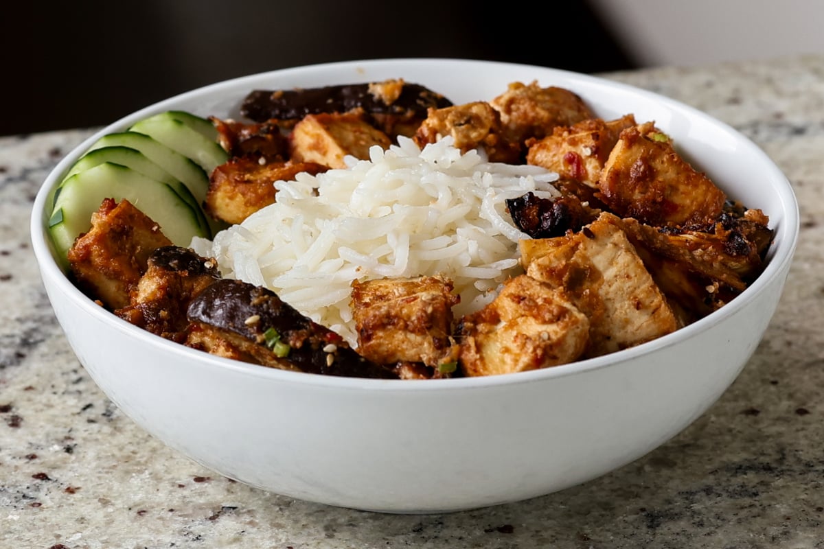 eggplant and tofu in the bowl with rice before adding toppings