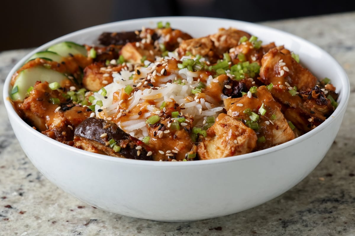 eggplant and tofu in the bowl with rice with all of the toppings