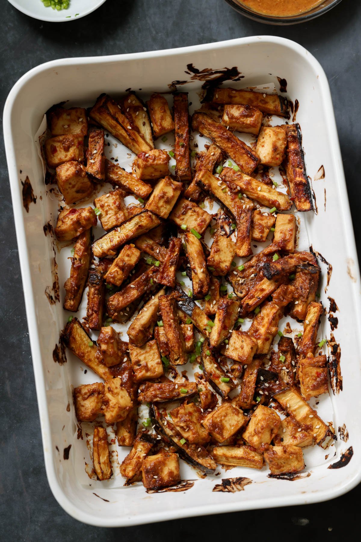 eggplant and tofu mixed with the peanut sauce spread into a lined baking pan after baking