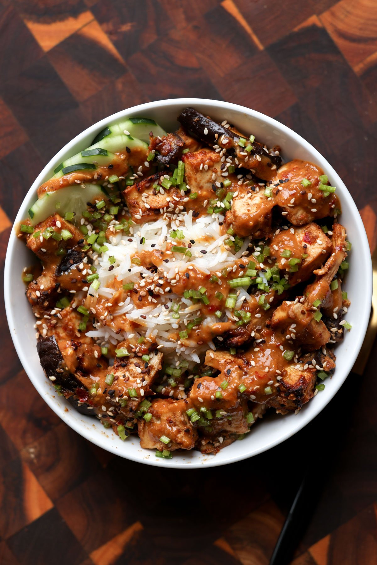 eggplant and tofu in the bowl with rice with all of the toppings