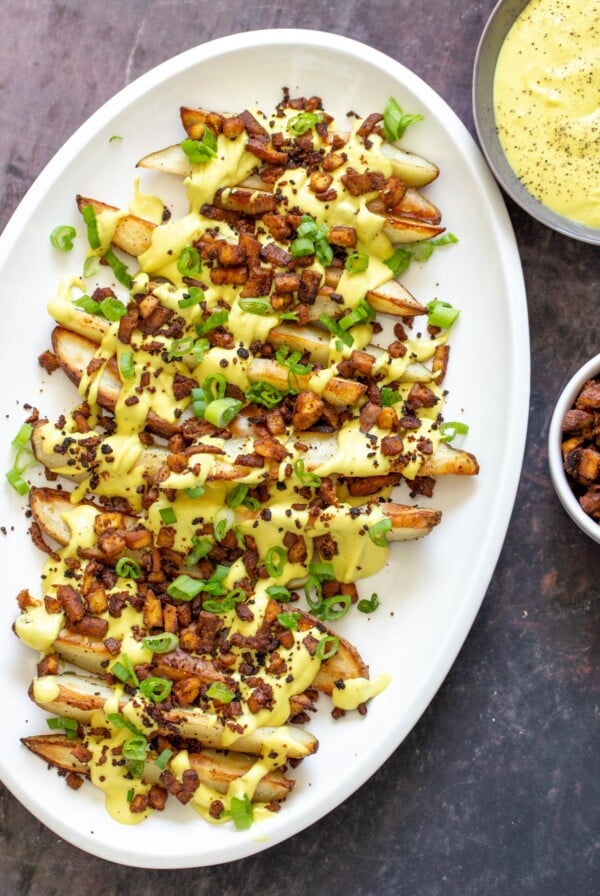 loaded baked potato wedges served with vegan cashew cheese sauce