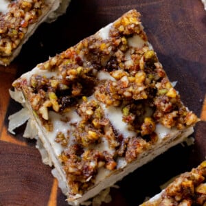 baklava cheesecake on a wooden cutting board, after slicing