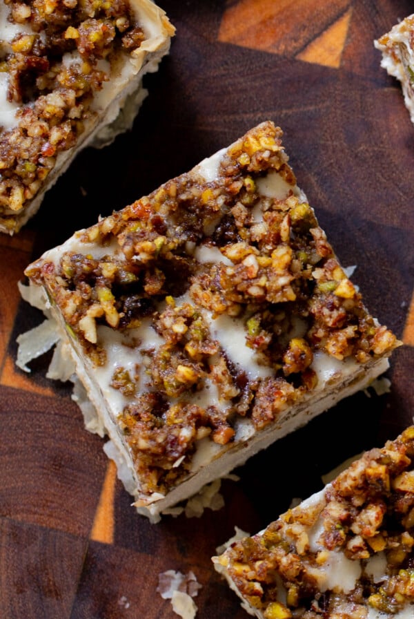 baklava cheesecake on a wooden cutting board, after slicing