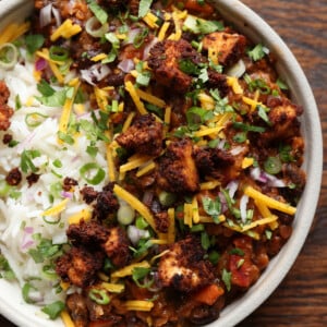 tofu chorizo burrito bowl with rice, pico de Gallo, and vegan cheese on top