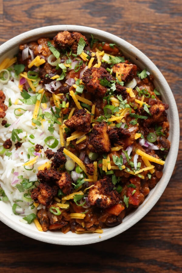 tofu chorizo burrito bowl with rice, pico de Gallo, and vegan cheese on top