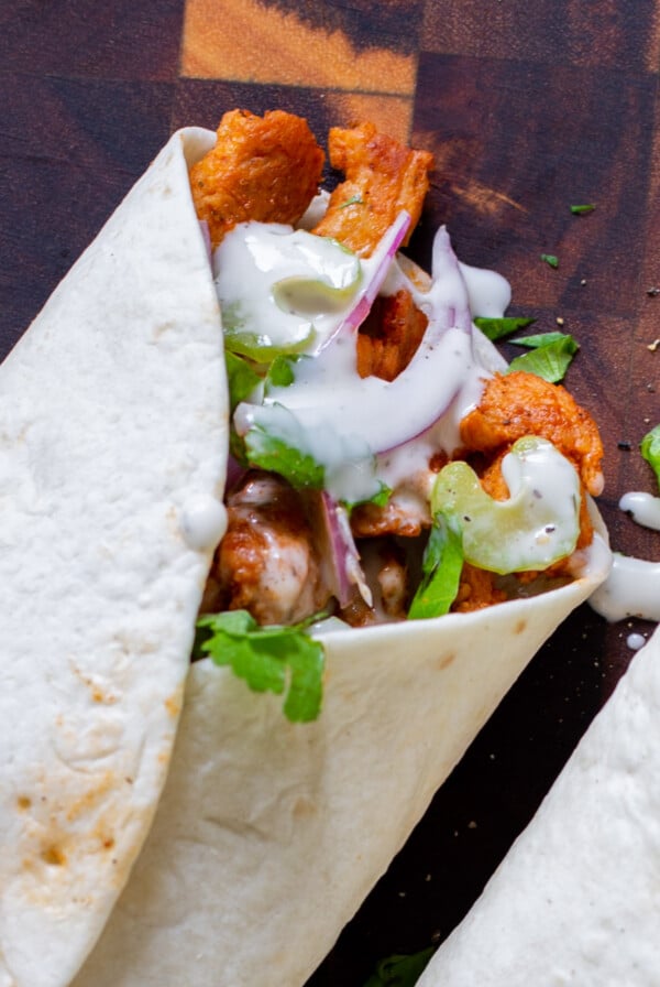 close-up of the top of a closed buffalo cajun wrap, so you can see the soy curls