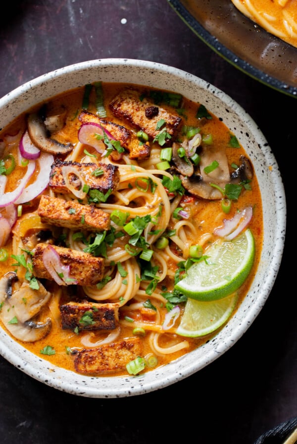 bowl of butter ramen with tofu and a lime wedge