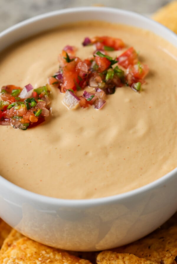 cashew nacho cheese in a serving bowl topped with salsa