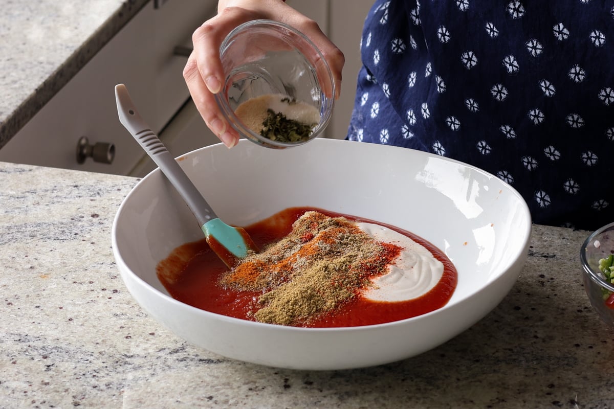 adding spices to the bowl