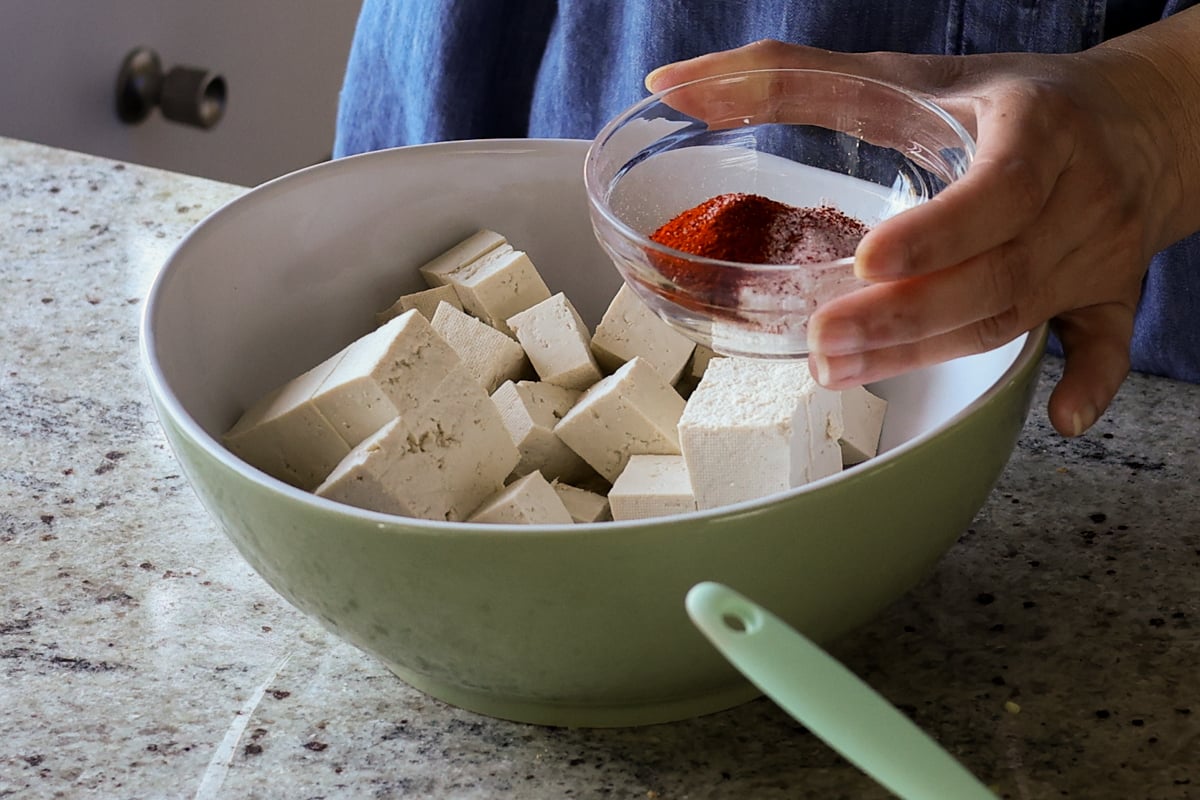 adding spices to the tofu