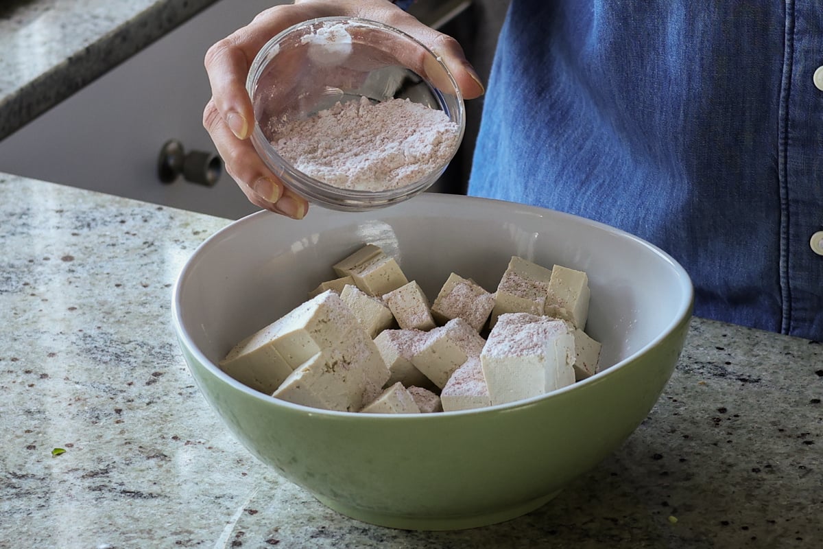 adding cornstarch to the tofu