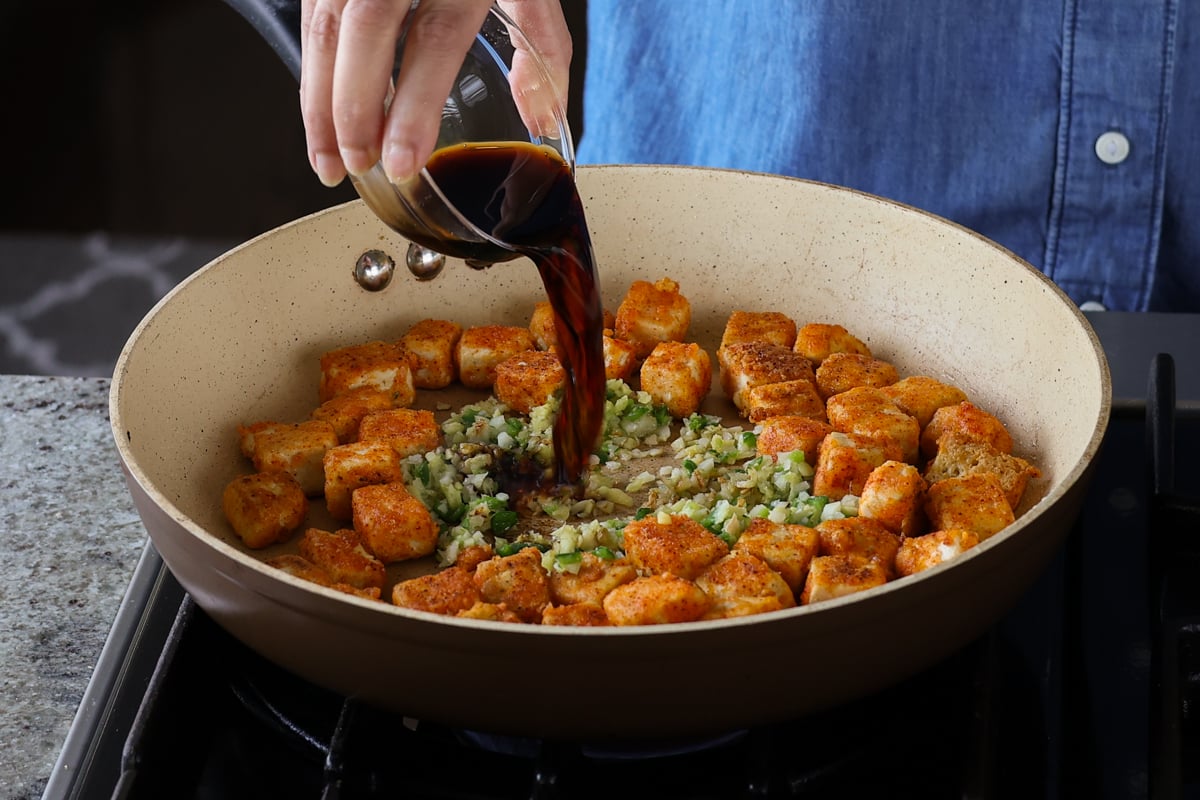 adding soy sauce and vinegar to the pan