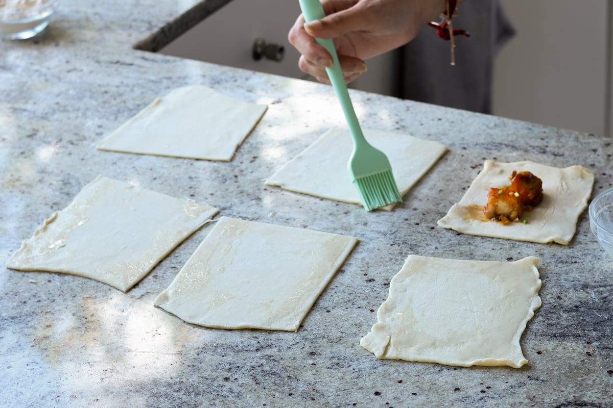 brushing puff pastry with maple-milk mixture