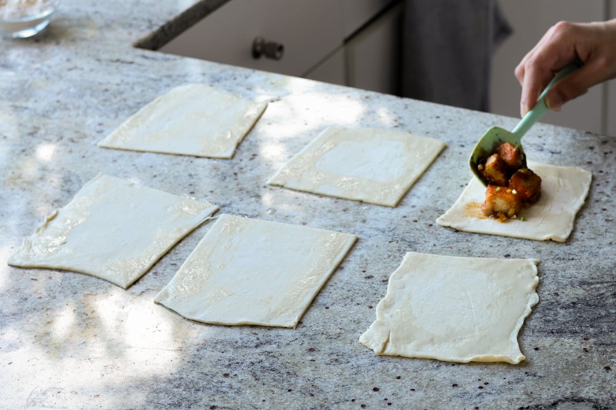 adding tofu filling to the puff pastry