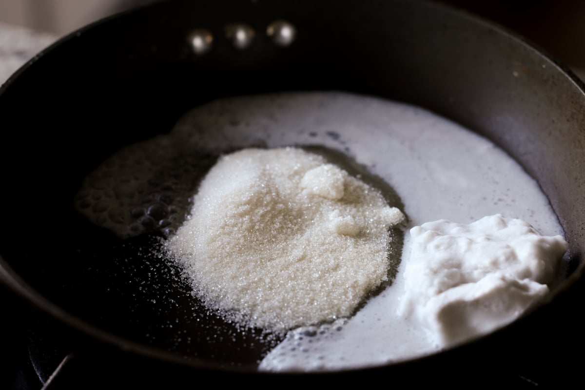 mixing the coconut milk and sugar in a pan