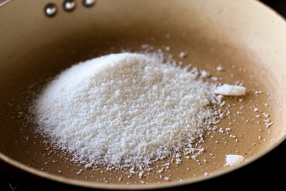 adding coconut to the pan