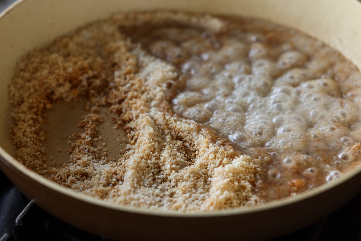 adding condensed coconut milk mixture to the toasted coconut