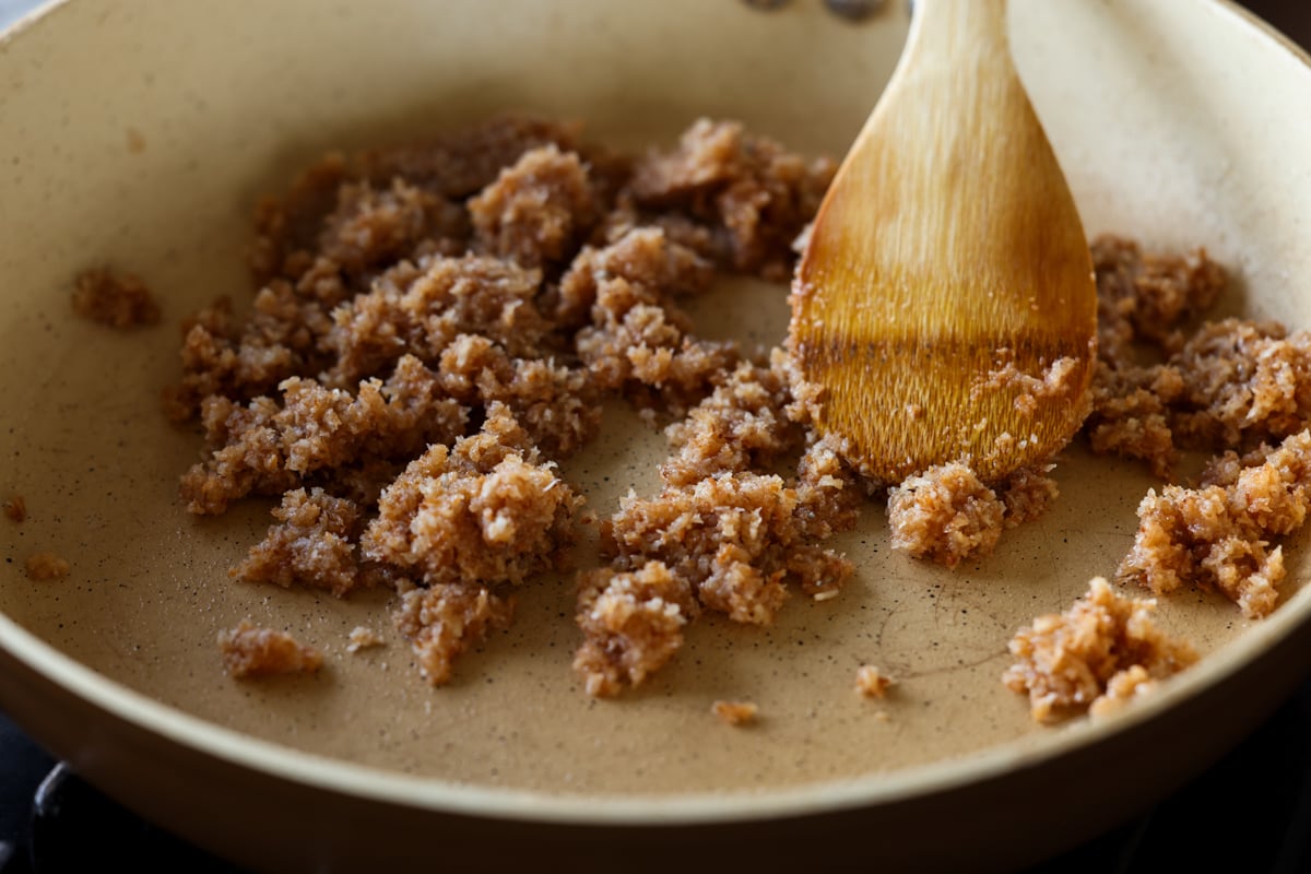 mixing coconut, condensed milk, and cardamom