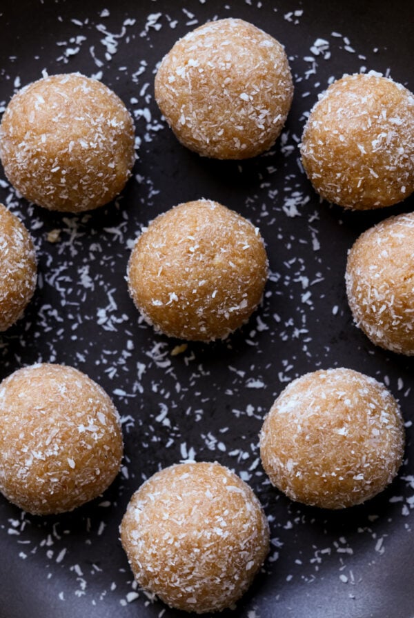 toasted coconut ladoo on a black plate