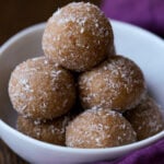 pile of toasted coconut ladoo on a white serving plate