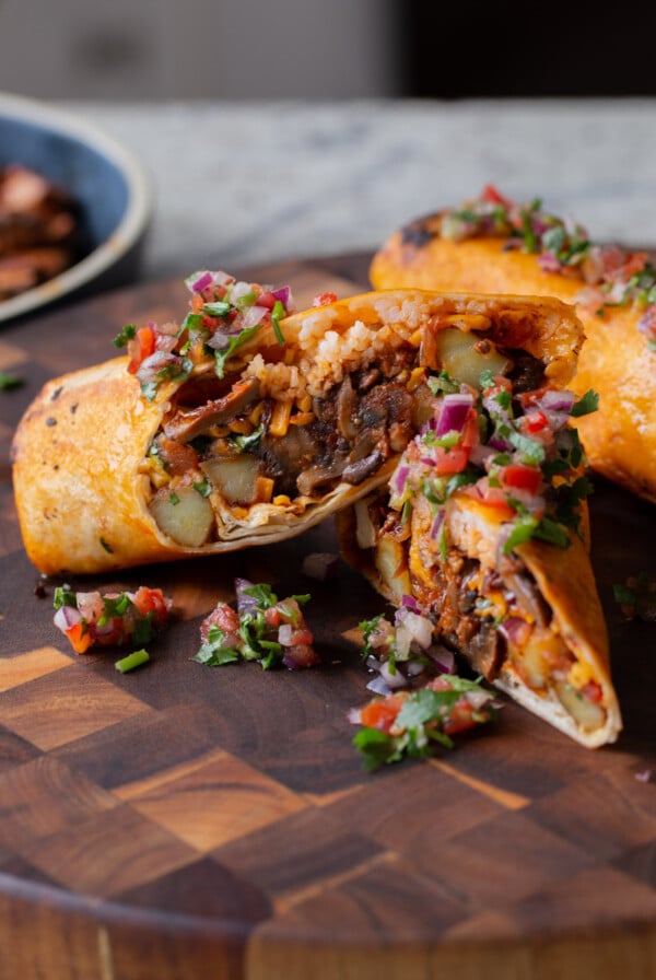 close-up of crispy tofu burrito cut in half so you can see the filling