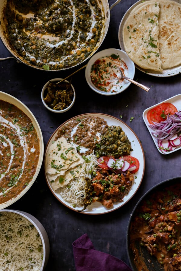 plateful of food from the diwali party menu surrounded by the serving dishes