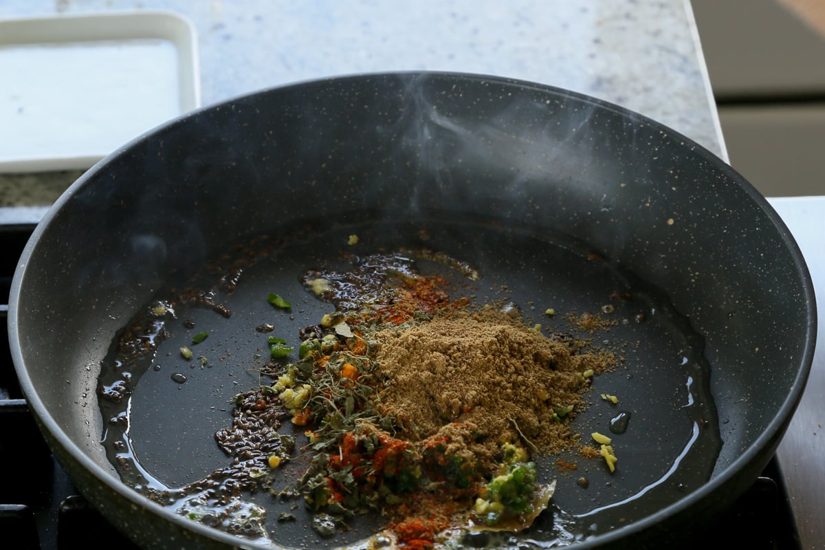 adding ground spices to the pan