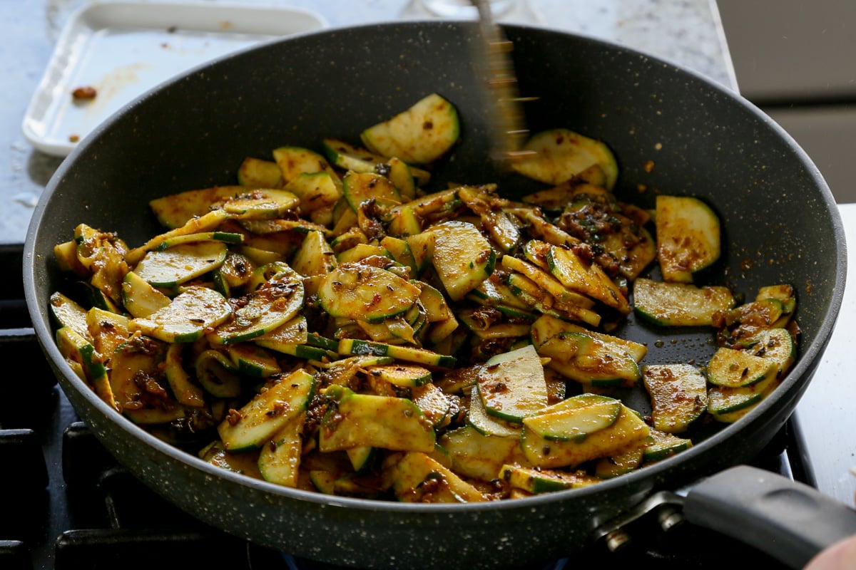 zucchini tossed in spices before cooking