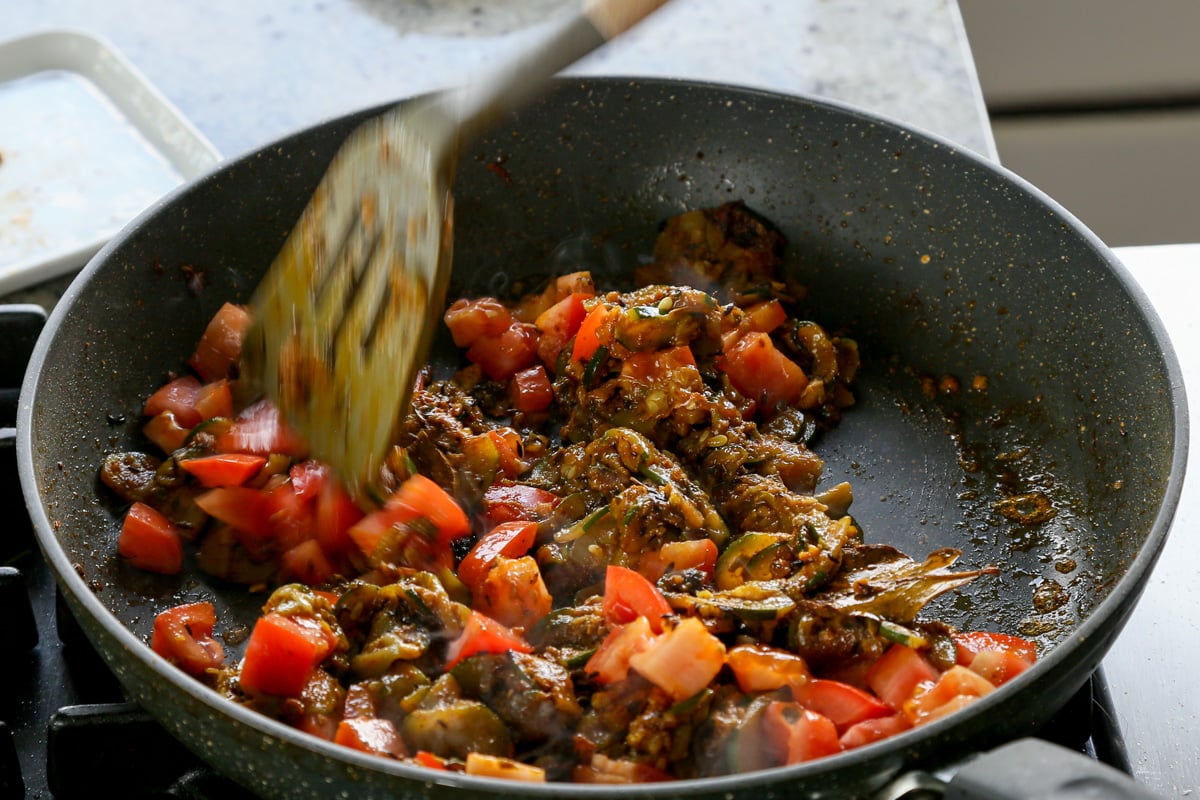 mixing in the tomato