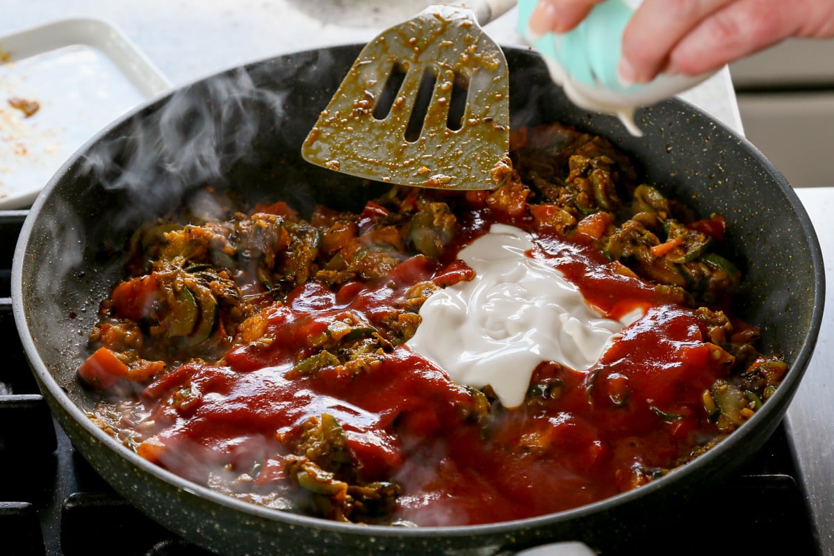 doing tomato puree and non-dairy yogurt to the pan