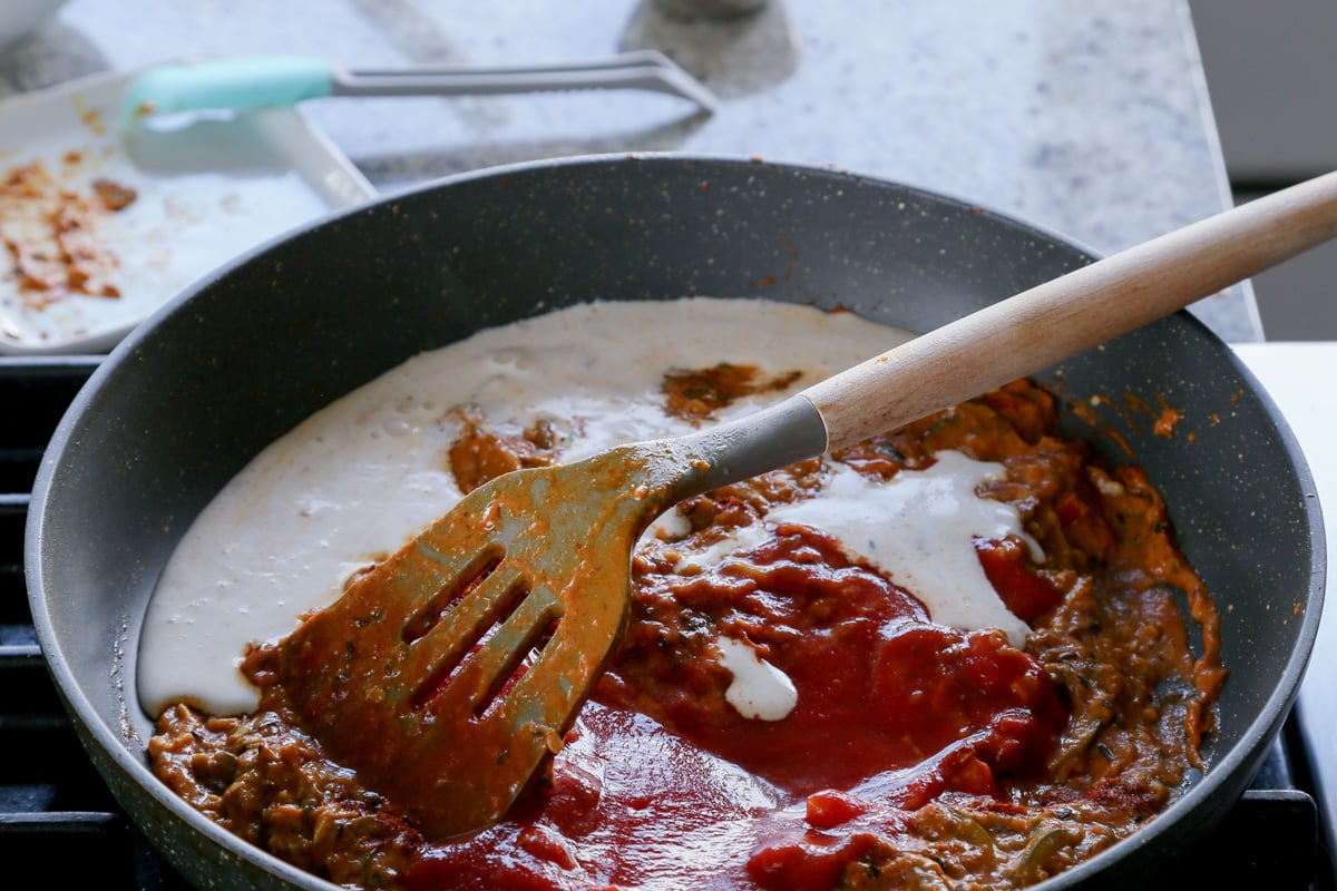 adding cashew cream to the sauce