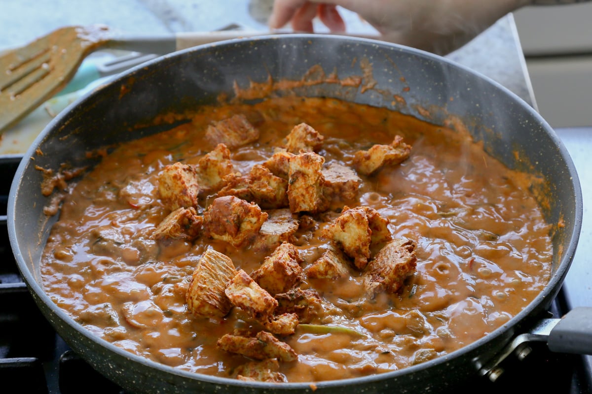 adding tofu to the tikka masala sauce