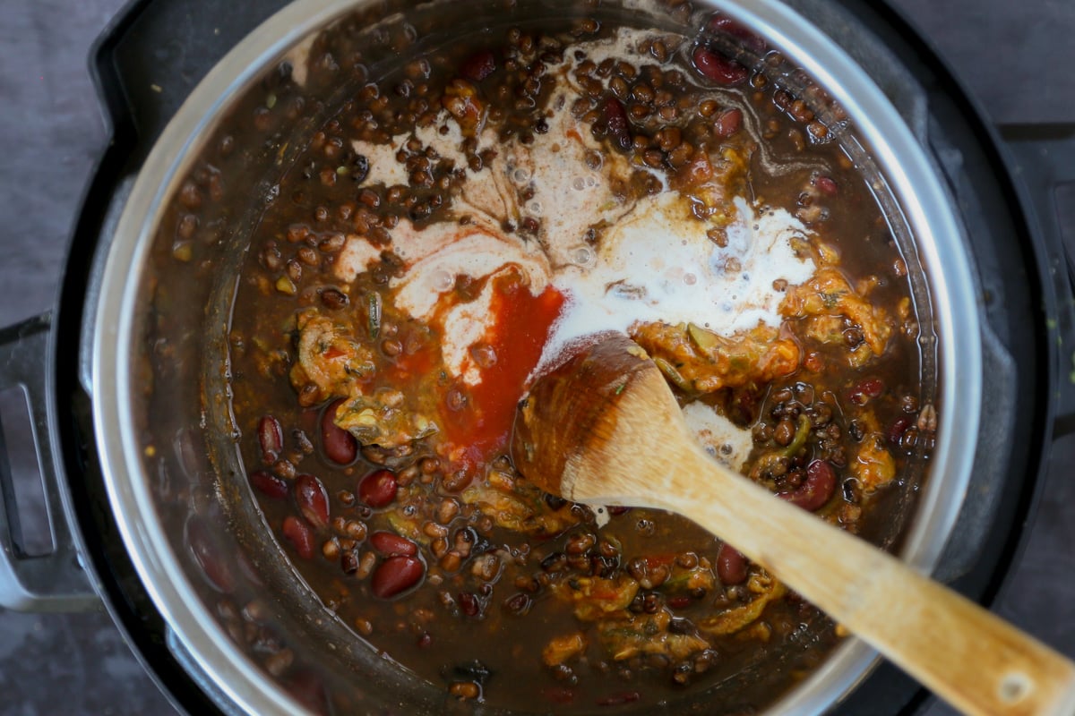 adding tomato puree to the dal