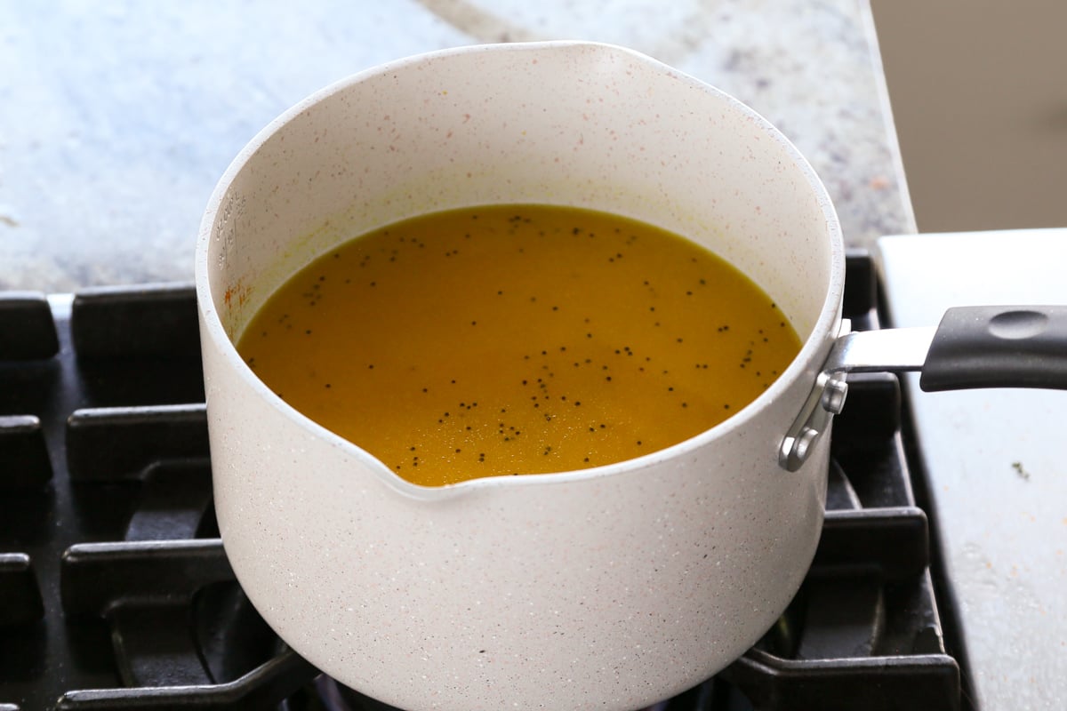 turmeric rice in the pan after adding water, before cooking