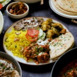 plate of no onion no garlic Diwali food surrounded by serving bowls