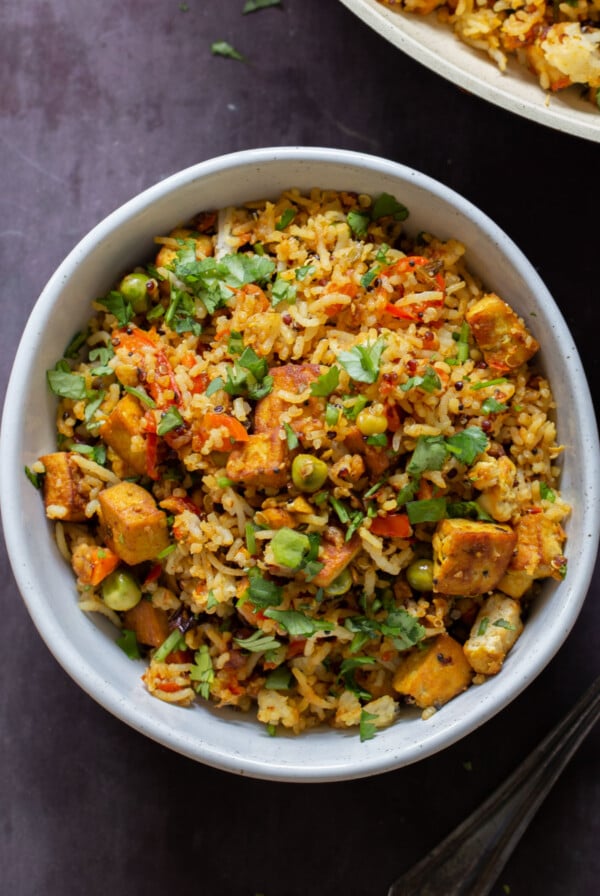 bowl of podi rice on the table with cilantro on top