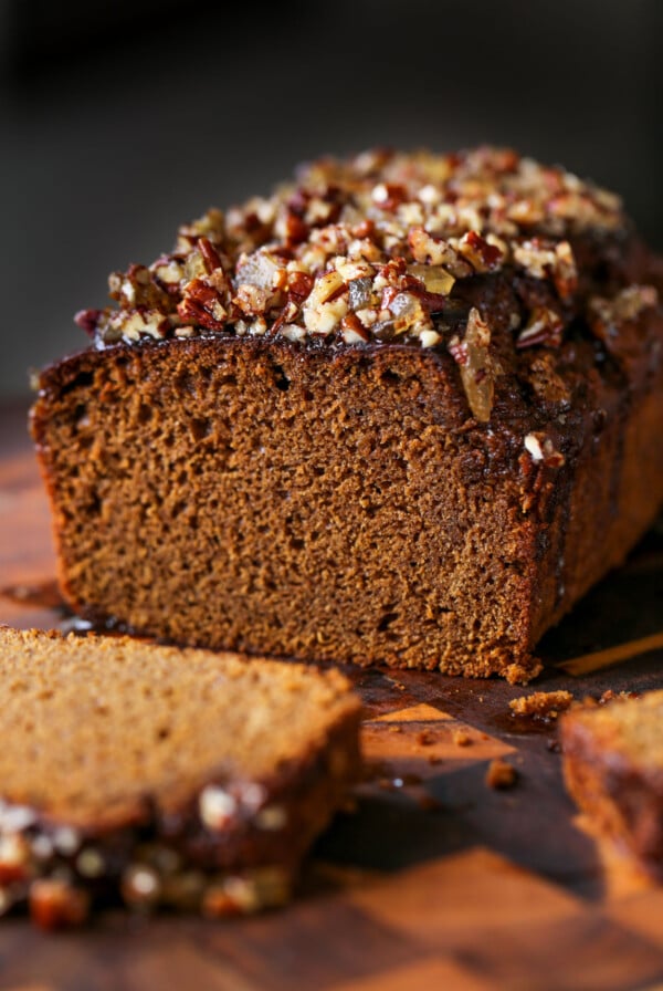 gingerbread cake on a cutting board with a slice cut out