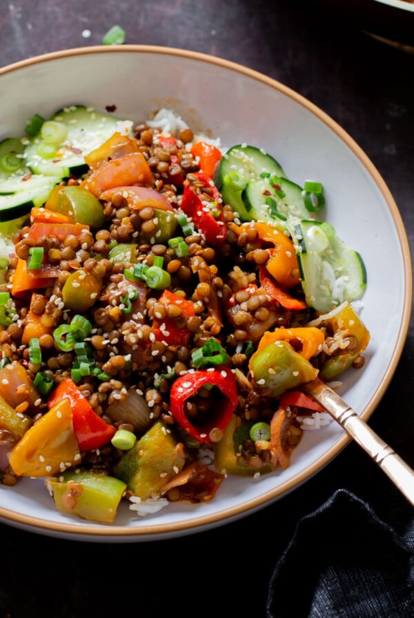 close-up of gochujang lentils in a bowl with bell pepper and onion