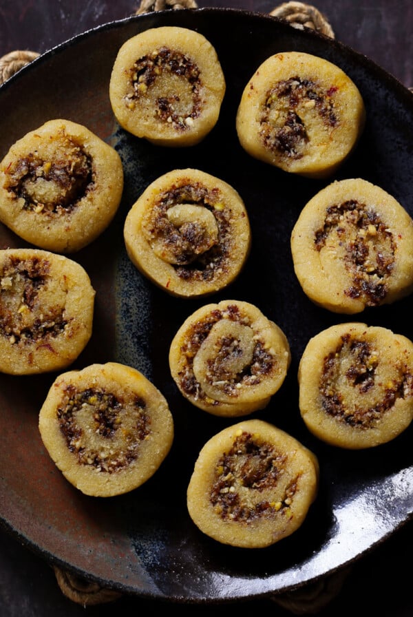 gujiya peda on a dark brown plate