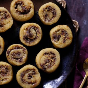 gujiya peda on a dark brown plate