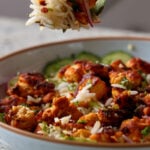 fork taking a bite of harissa tofu and herbed rice