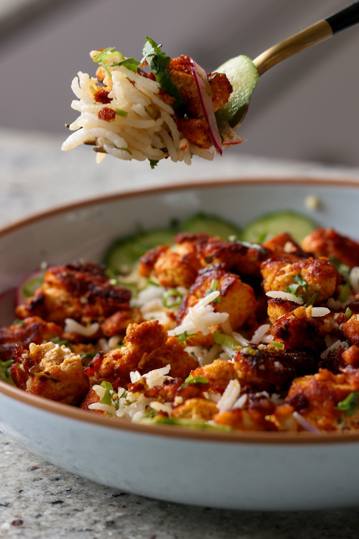 fork taking a bite of harissa tofu and herbed rice