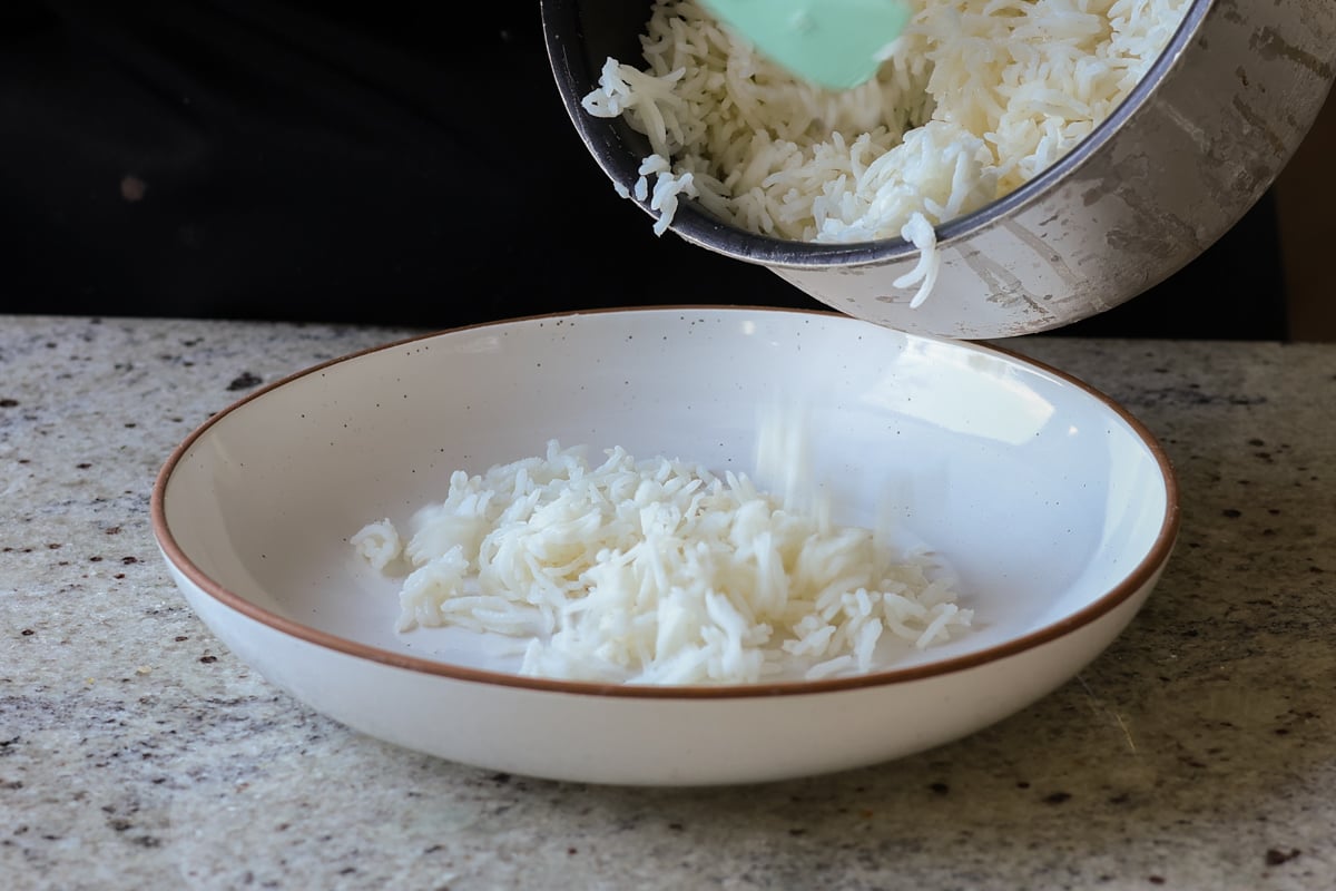 adding rice to the bowl