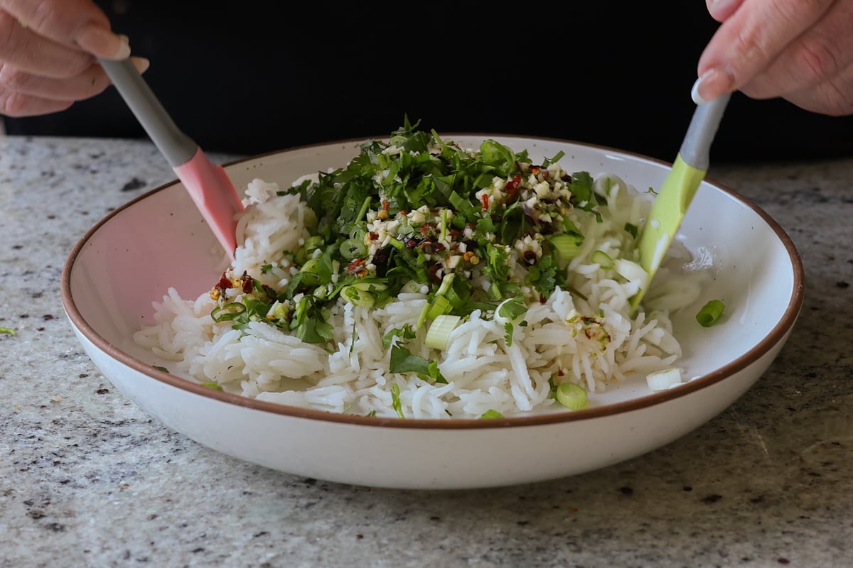 adding herbs to the rice