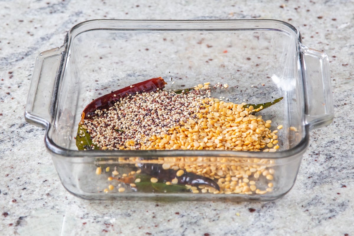 lentils being added to tempering in casserole dish