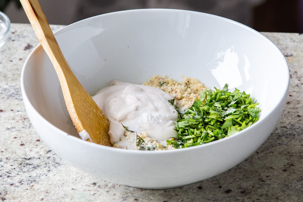 yogurt being added to topping for idli casserole